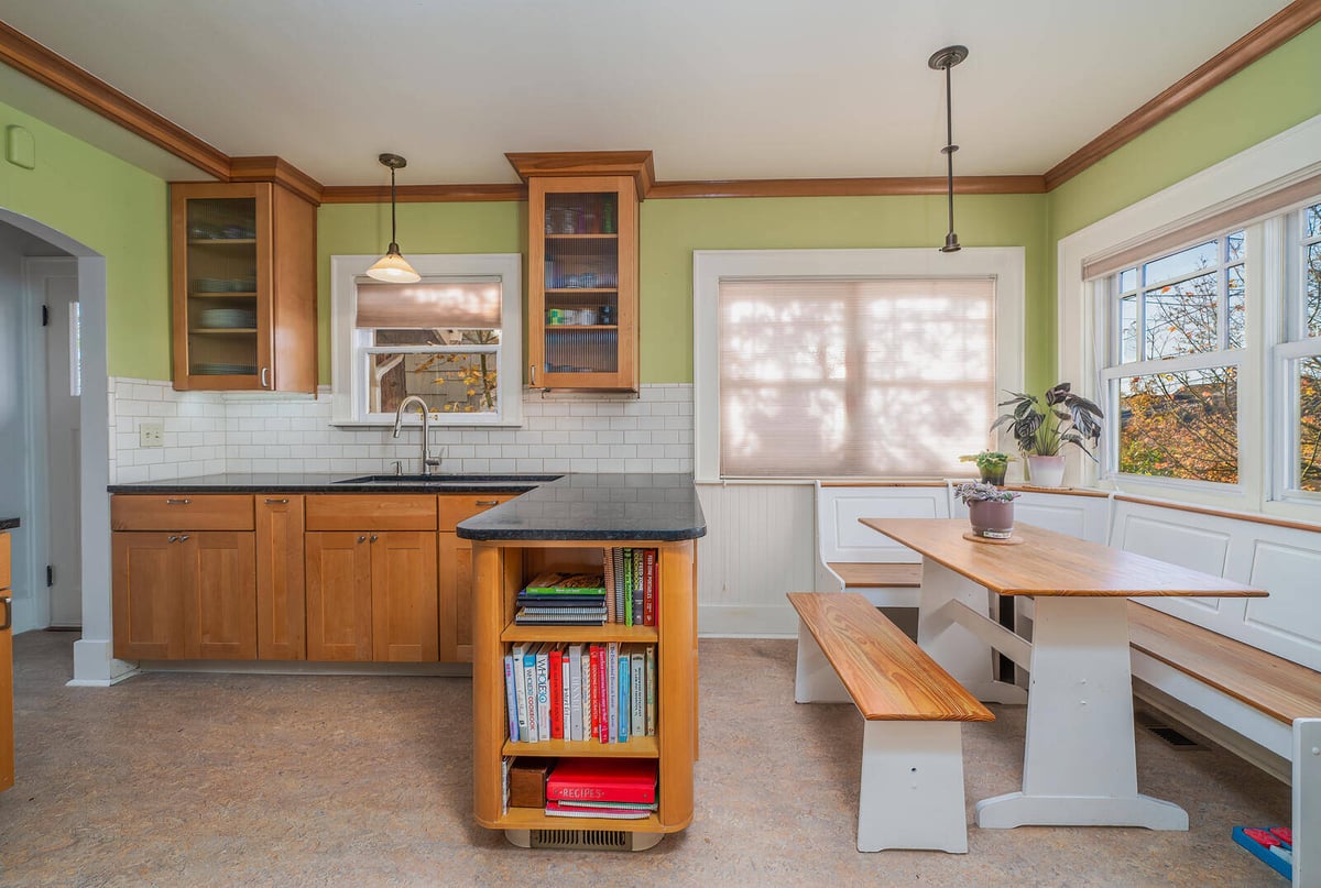 Spacious Seattle kitchen with an island and white tile backsplash, remodeled by CB Construction