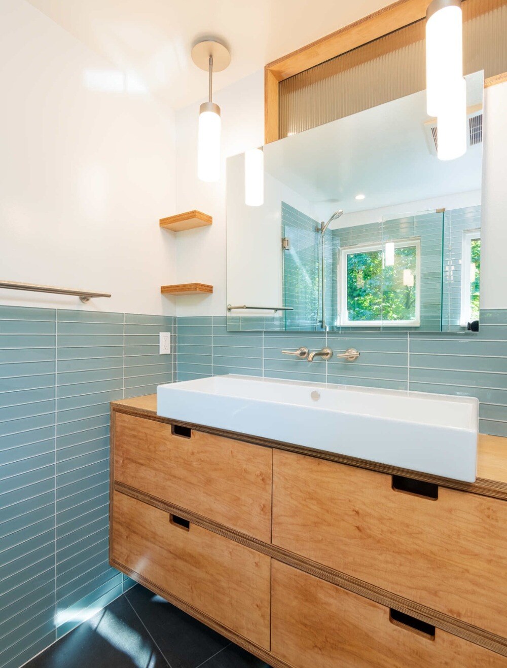 Contemporary bathroom with wood vanity and blue tile walls, remodeled by CB Construction in Seattle-1