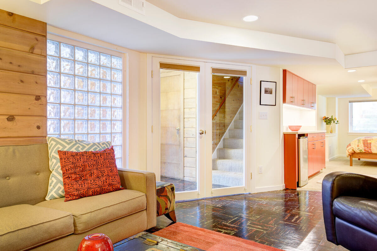 Bright and modern basement Airbnb entrance with glass doors, remodeled by CB Construction in Seattle