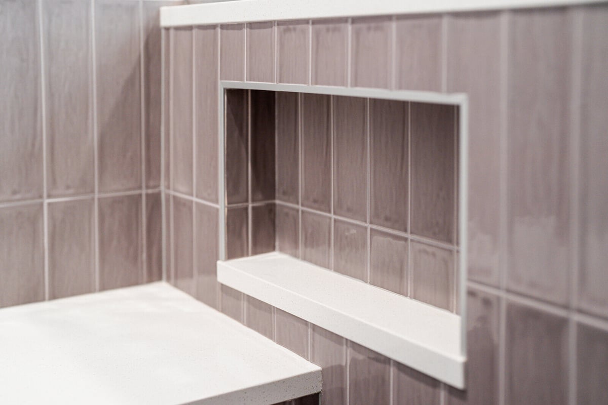 Built-in niche in a tiled shower, part of a Seattle ADU remodel by CB Construction