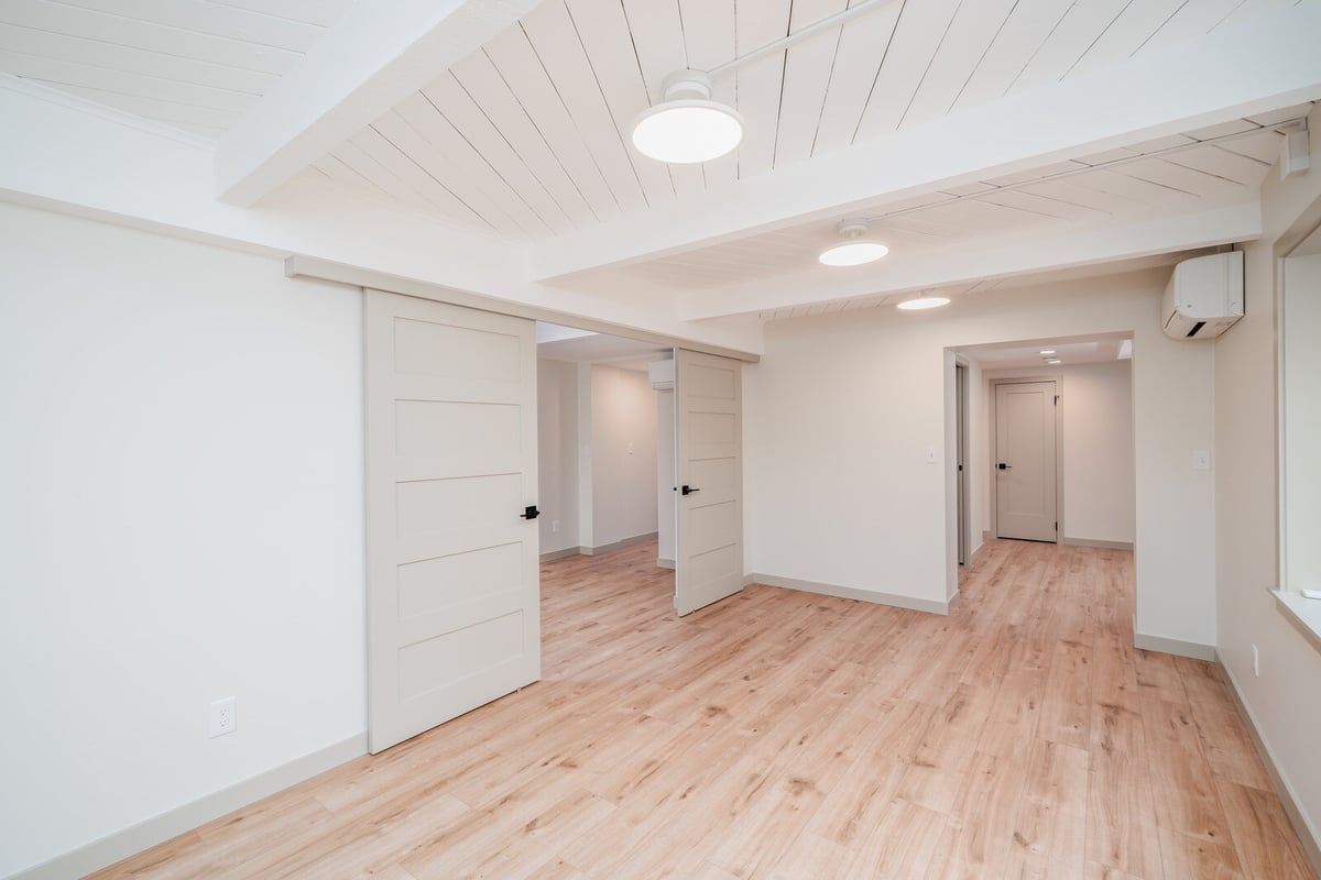 Renovated basement ADU in Seattle with sliding doors and wood flooring, completed by CB Construction