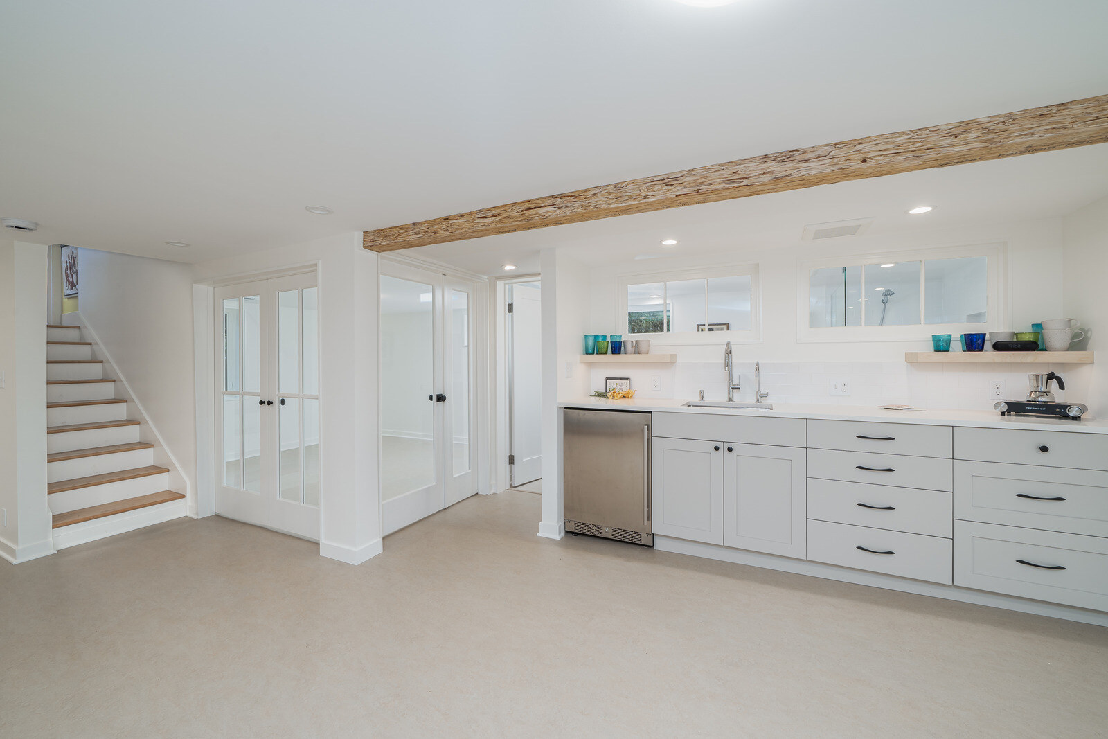 Bright basement kitchenette with modern cabinetry and sink in a Seattle remodel by CB Construction