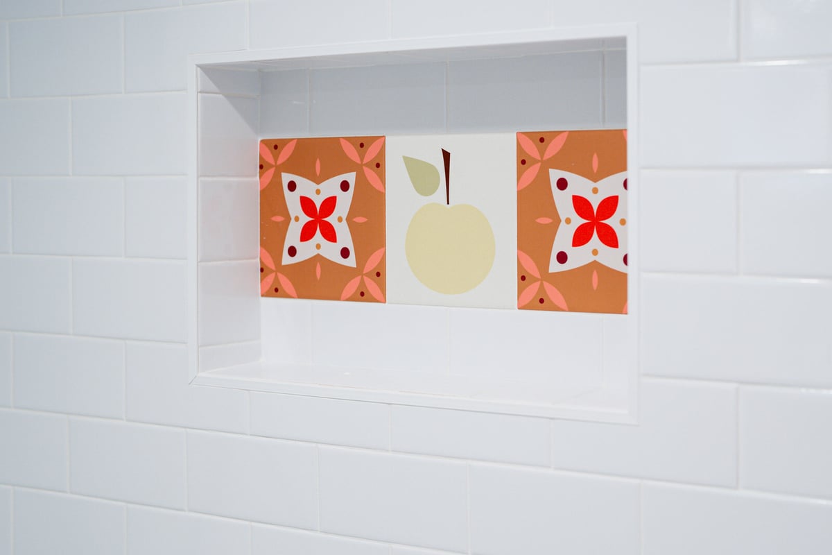 Patterned tile design in a recessed shower shelf, Seattle basement remodel by CB Construction