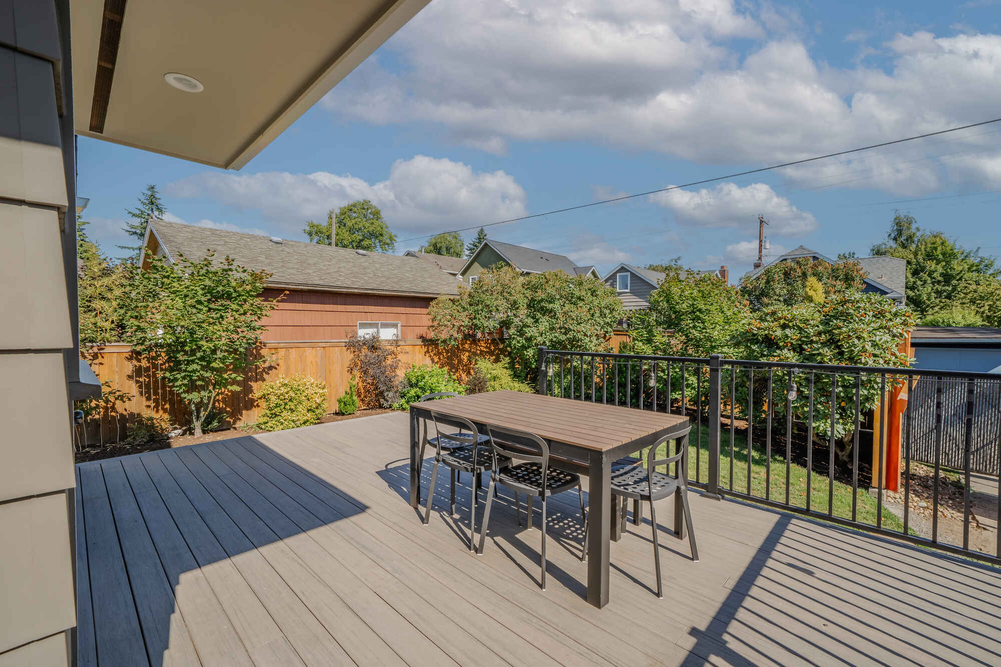 Seattle backyard deck remodel by CB Construction featuring outdoor furniture and railings