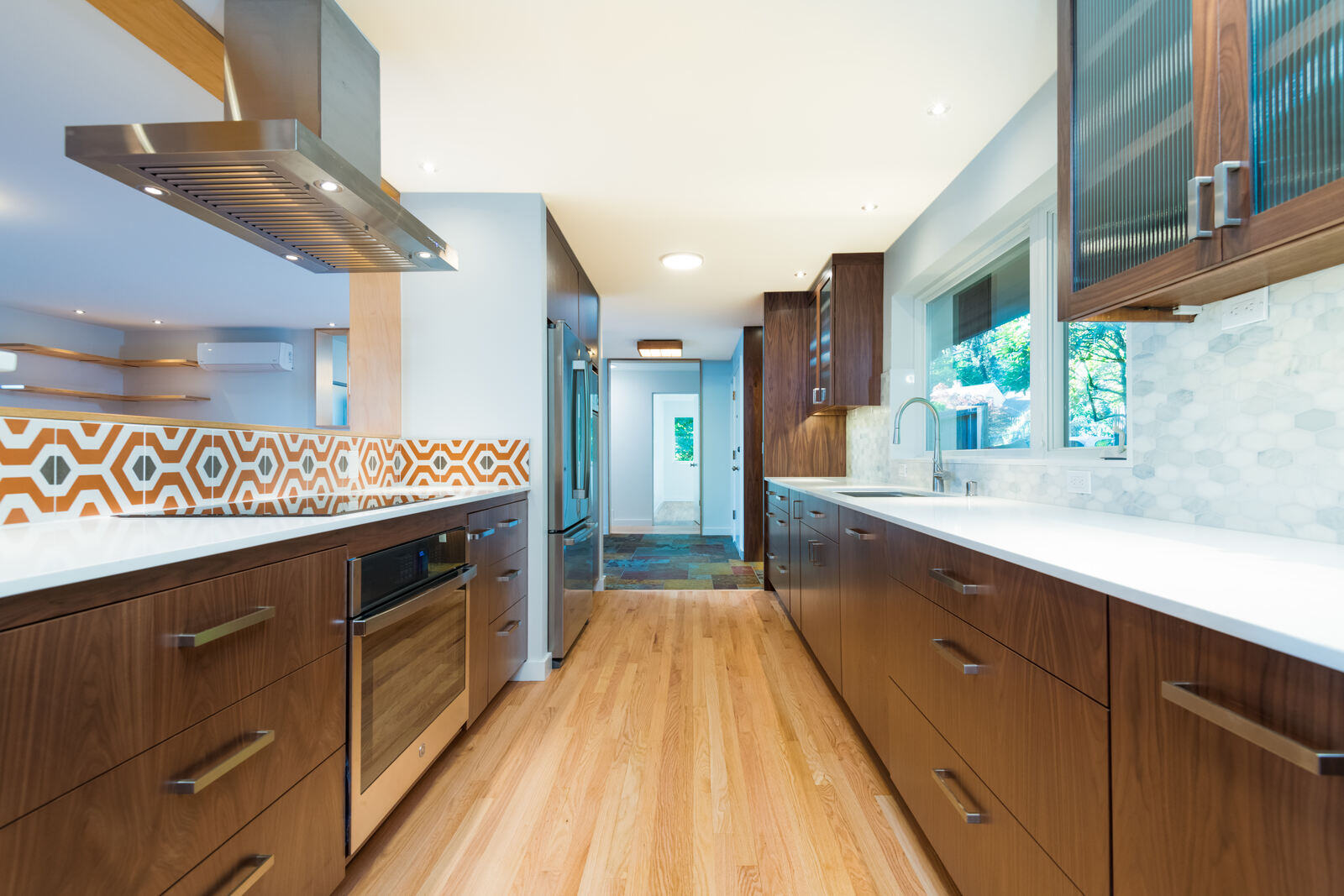 Open kitchen design with rich wood cabinets and vibrant backsplash, CB Construction, Seattle