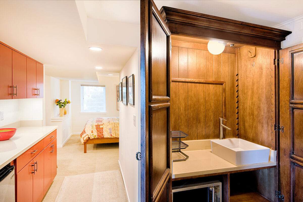 Compact kitchenette and bedroom space in a Seattle basement Airbnb remodel by CB Construction