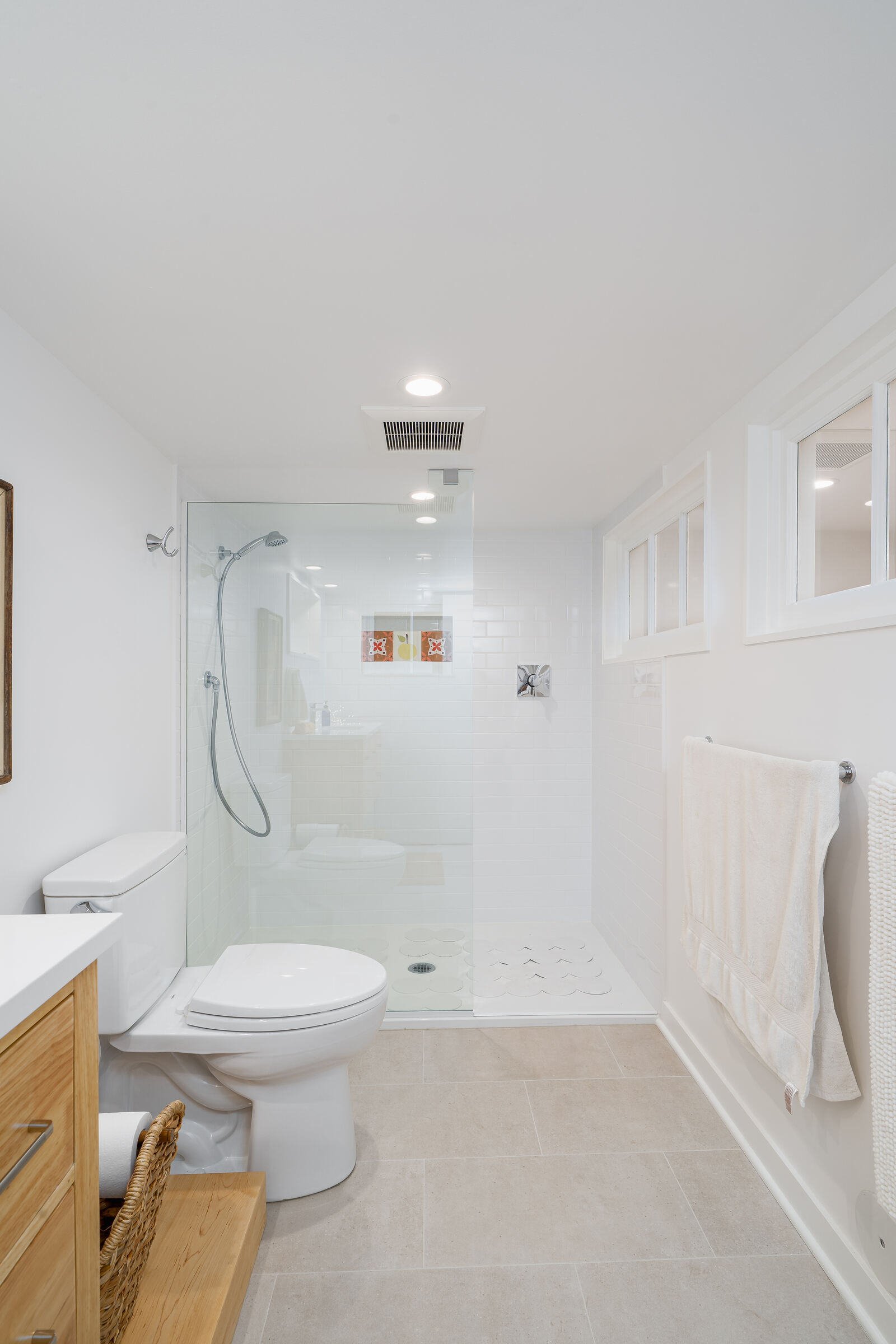 Walk-in shower and modern toilet in a remodeled basement bathroom by CB Construction in Seattle